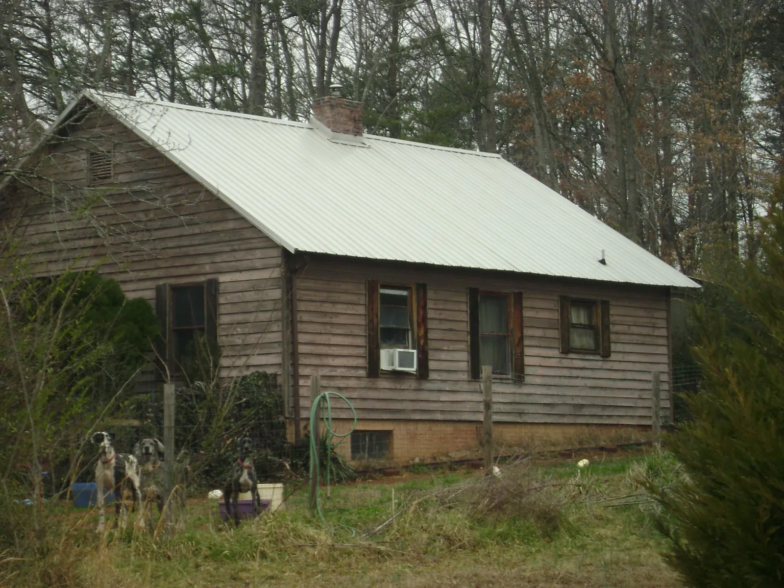 White metal roof on an old wood sided farmhouse, from a Metal Roof Installation job in Waterford